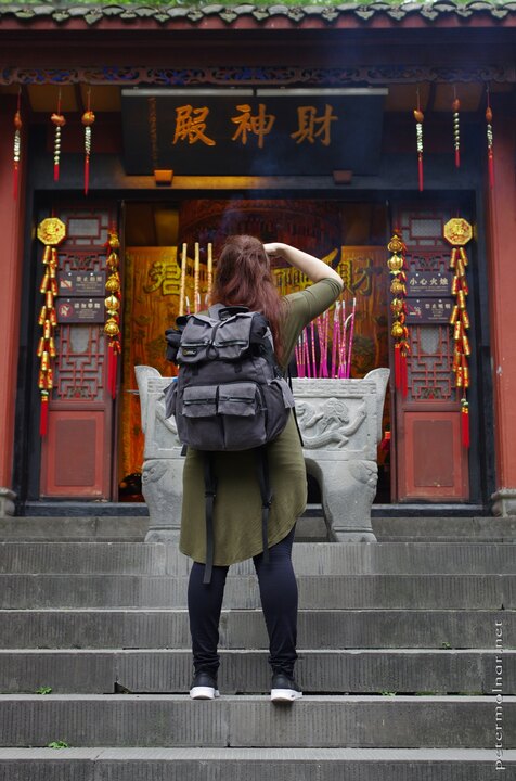 Dujiangyan Scenic Area - Nora taking a picture of incests in front of
a shrine