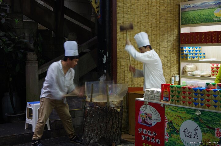 Making sweets with hammers while singing works songs at the foot of
Mount Qingcheng